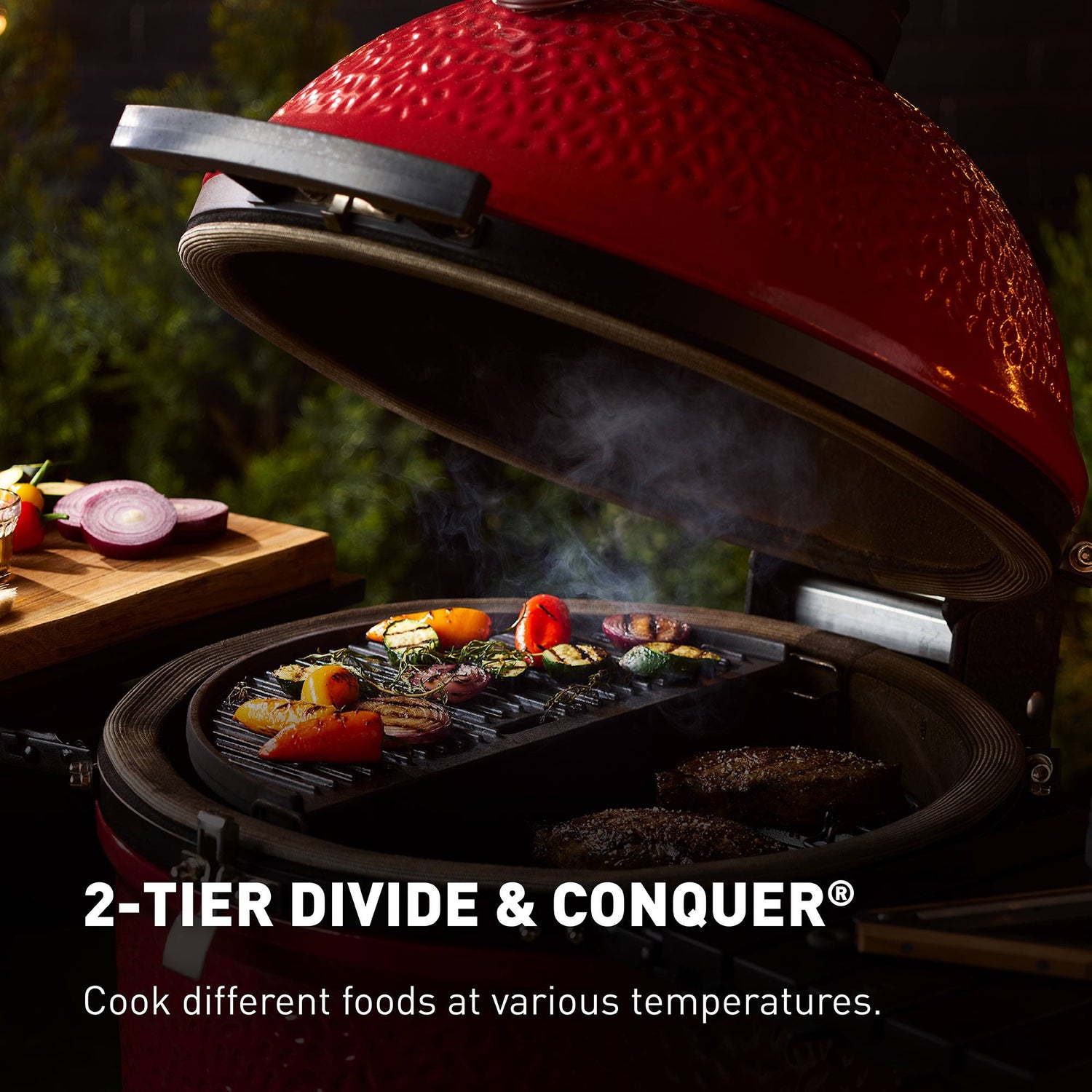 Red barbecue grill with food being cooked, featuring the text '2-Tier Divide & Conquer'.