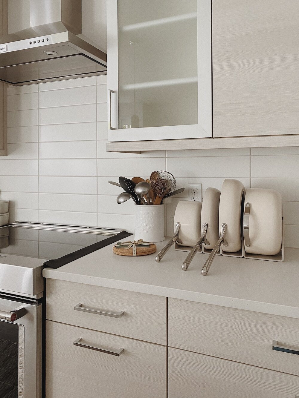 Caraway Cream Cookware Set in Storage on Kitchen Counter