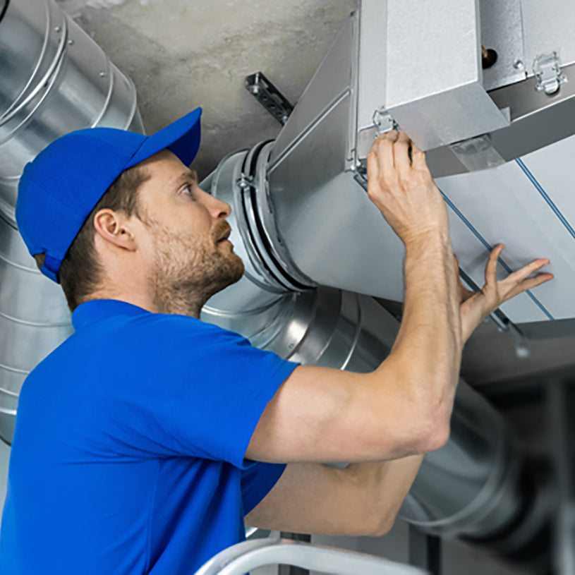 a technician performing a repair on an hvac unit
