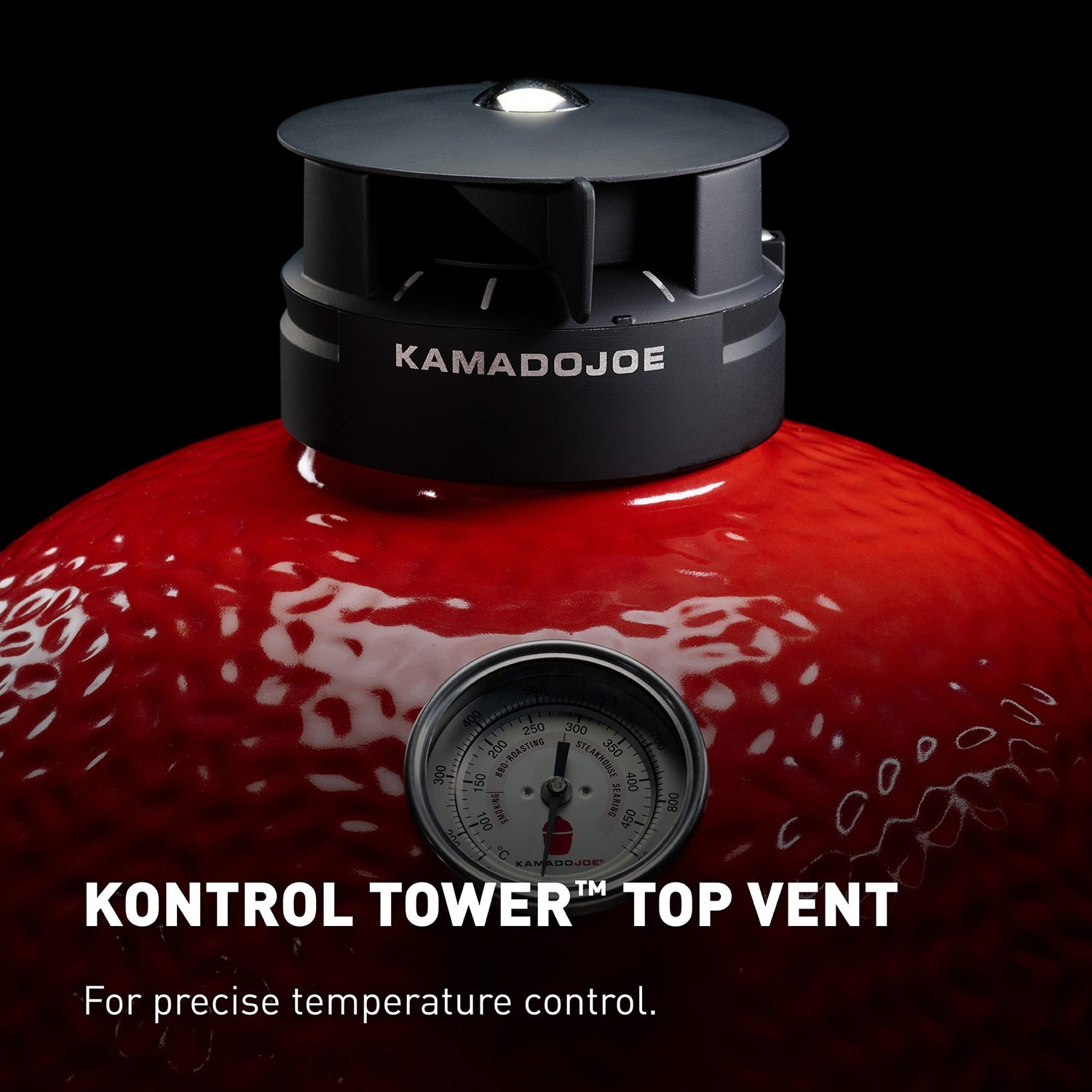 Kamado Joe grill with control tower top vent on a black background
