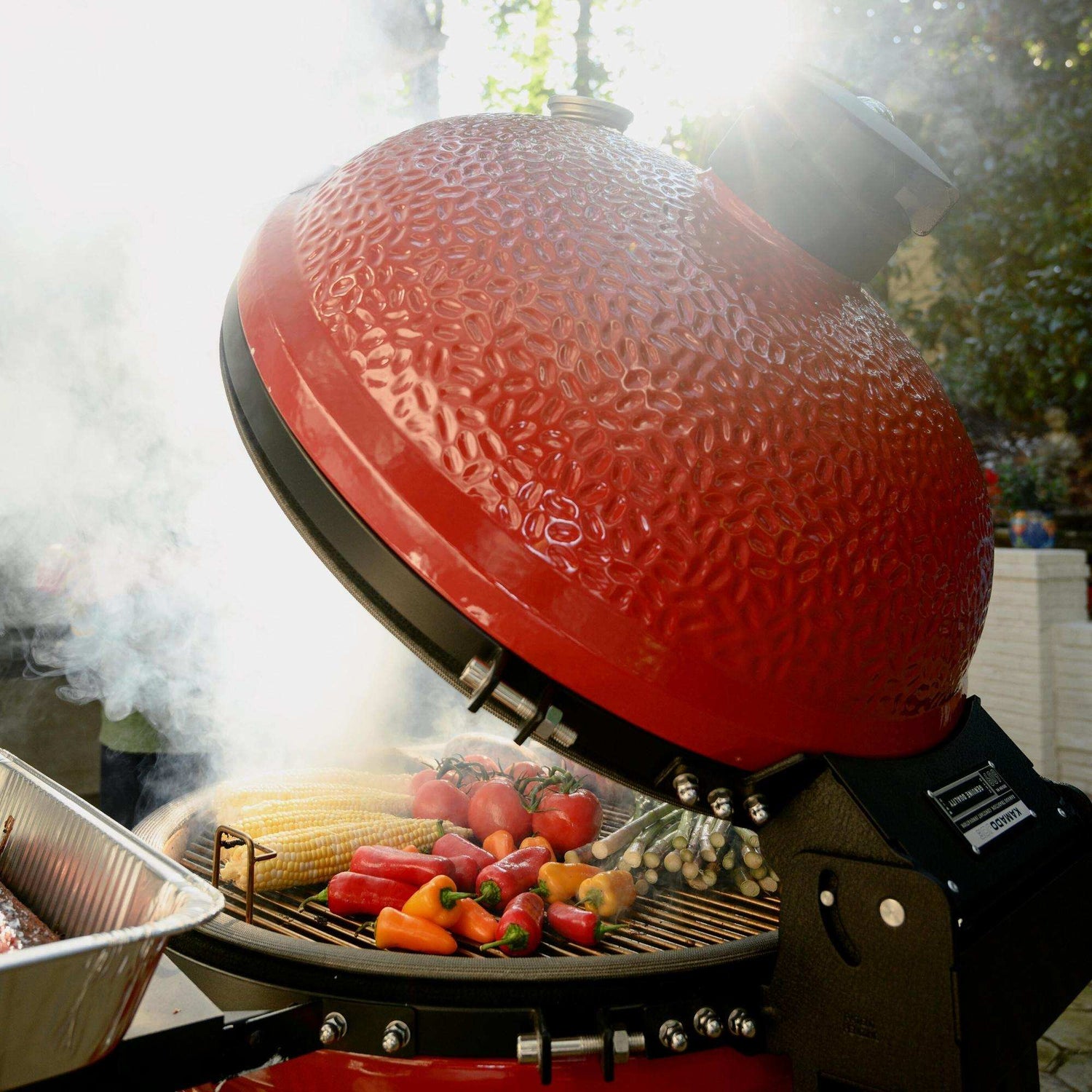 Red grill with vegetables being cooked outdoors