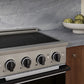 ZLINE Autograph 24 in. 3.2 cu. ft. Marino Induction Range with 3 Element Cooktop and Electric Convection Oven in Satin Stainless Steel with White Matte Door and Matte Black Accents, MINRSZ-WM-24-MB - Lifestyle Photo 3