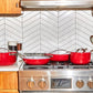 Caraway Red Cookware Set on Kitchen Range