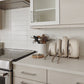 Caraway Cream Cookware Set in Storage on Kitchen Counter